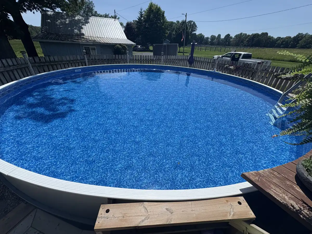 Same above ground pool with a new blue patterned liner, filled