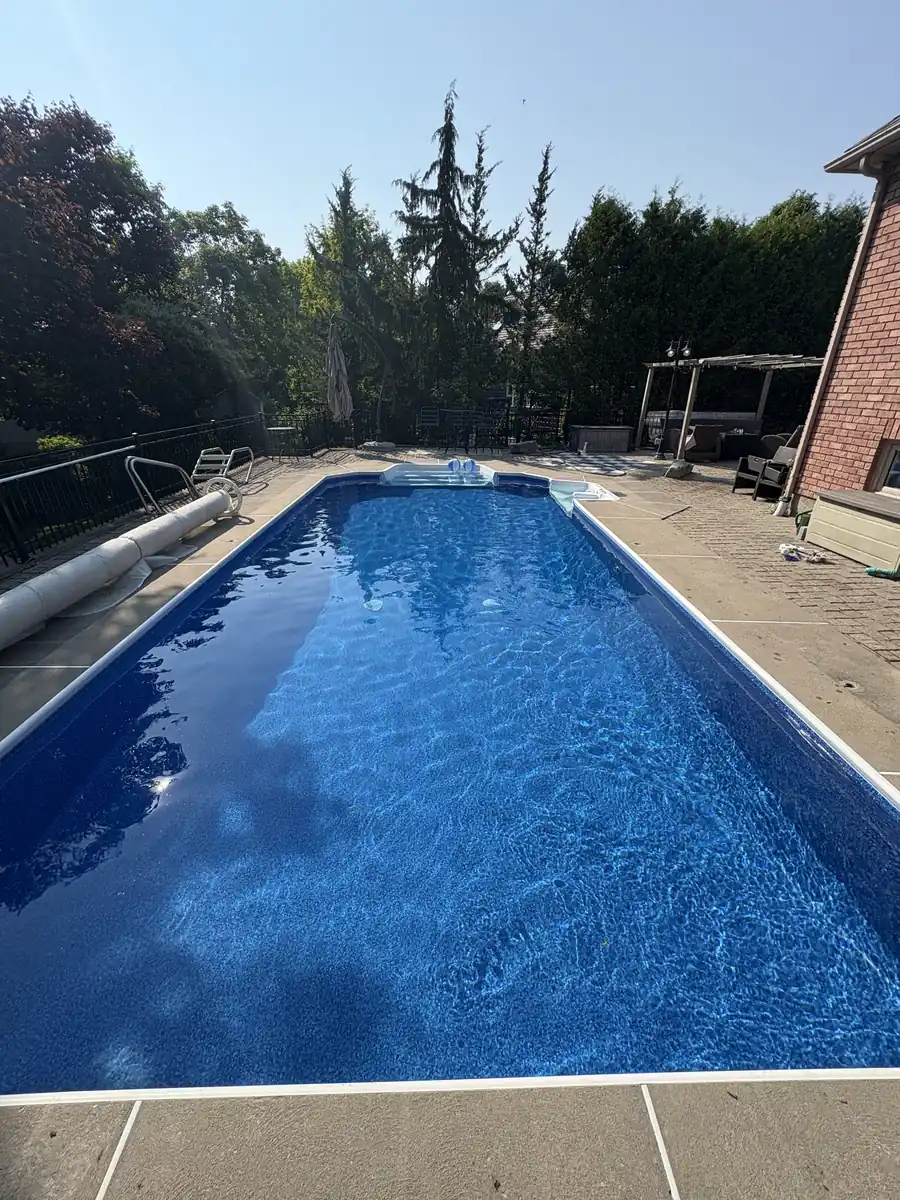 Finished rectangular pool with a new blue liner and clear water