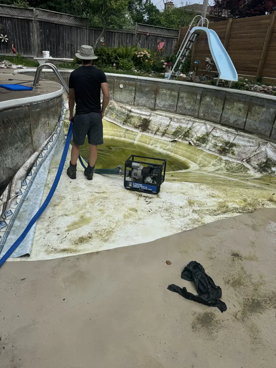 Kidney pool with a slide, drained and the old liner removed